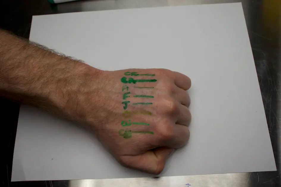 a hand with green paint on it